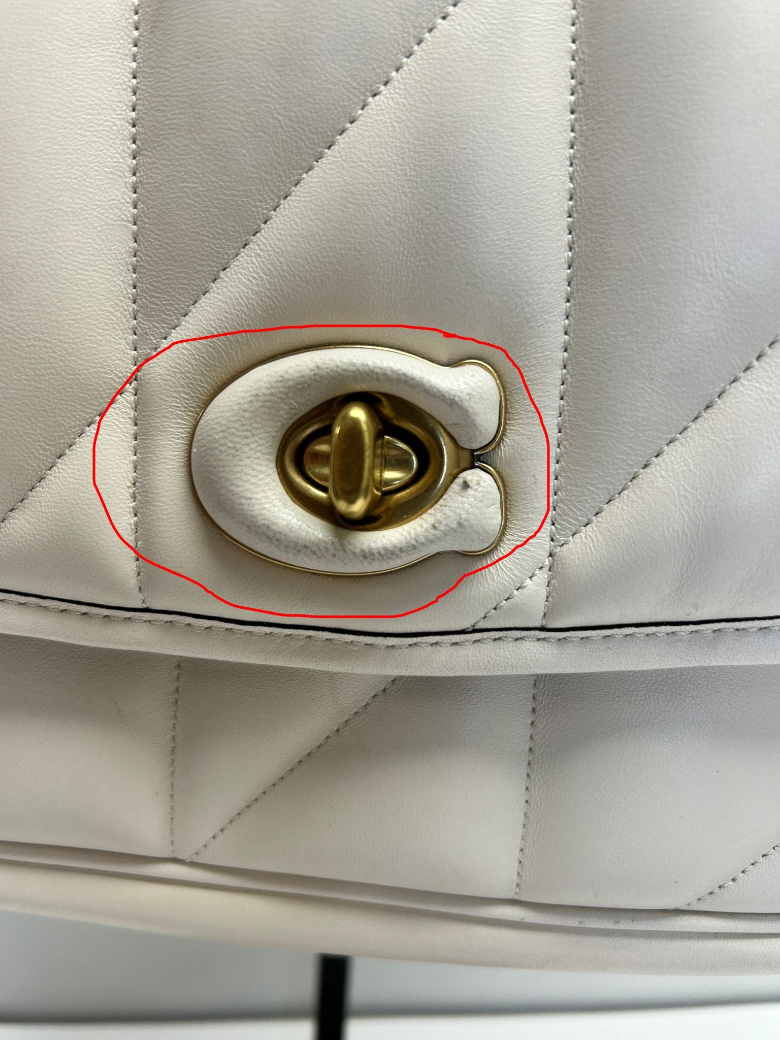 Leather 'C' logo damaged by handling in-store, almost imperceptible